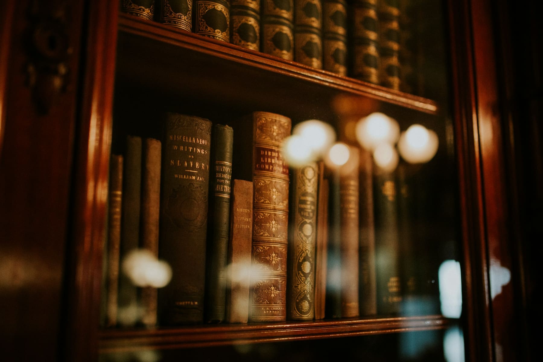 Leather-bound law books in a glass bookcase